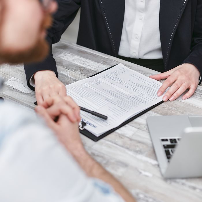 pexels photo 7731400 7731400 Two people in a business meeting reviewing documents on a clipboard.